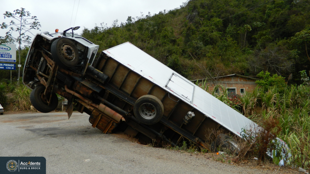 Box truck tipped onto its side off the edge of a rural road after losing control