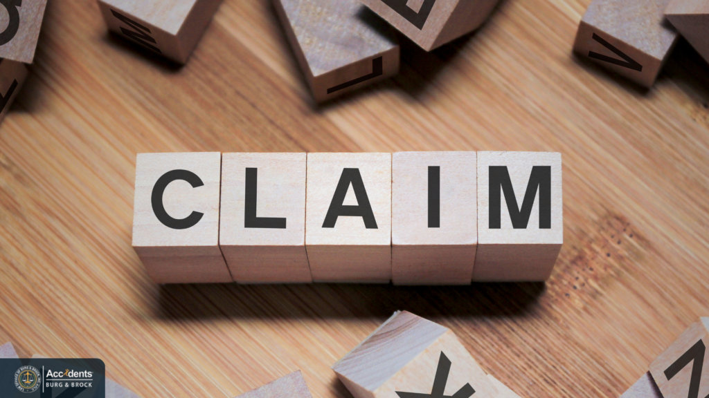 Filing a truck accident claim Wooden letter blocks spelling the word CLAIM on a wooden surface, surrounded by scattered blocks